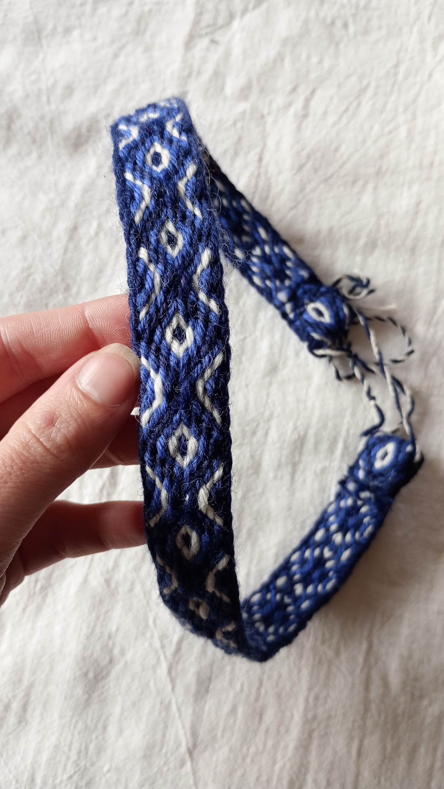 Bright blue headband with white diamond pattern